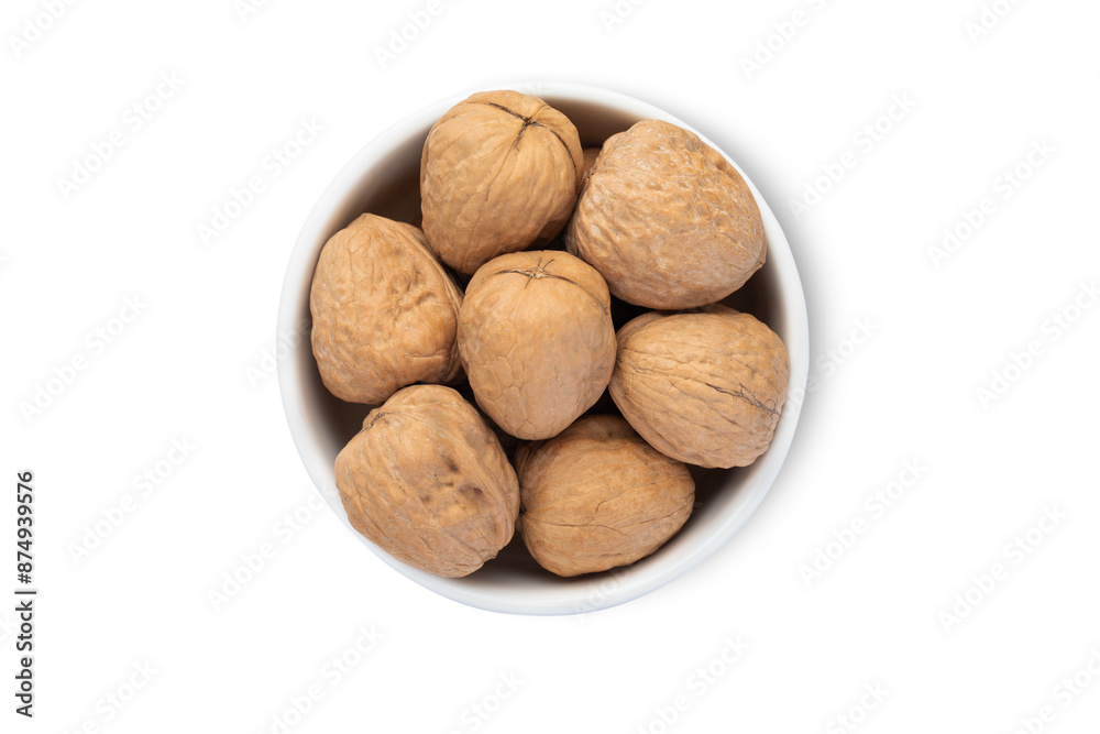 Ceramic bowl with organic walnut nuts with shell isolated on white background.Top view. Ceramic bowl with organic walnut nuts with shell isolated on white background.Top view.