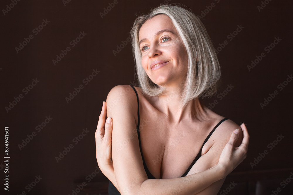 Attractive middle-aged woman enjoys herself and her body, loves herself Attractive middle-aged woman enjoys herself and her body, loves herself