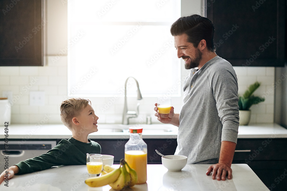 Family, breakfast and orange juice for morning in kitchen for nutrition, health and development. Happy, kid and dad for cereal with fruit for fiber or vitamins, growth and wellness on weekend in home Family, breakfast and orange juice for morning in kitchen for nutrition, health and development. Happy, kid and dad for cereal with fruit for fiber or vitamins, growth and wellness on weekend in home