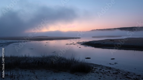 Fog rolling through an estuary at sunrise, creating an ethereal and mystical atmosphere. © atipong