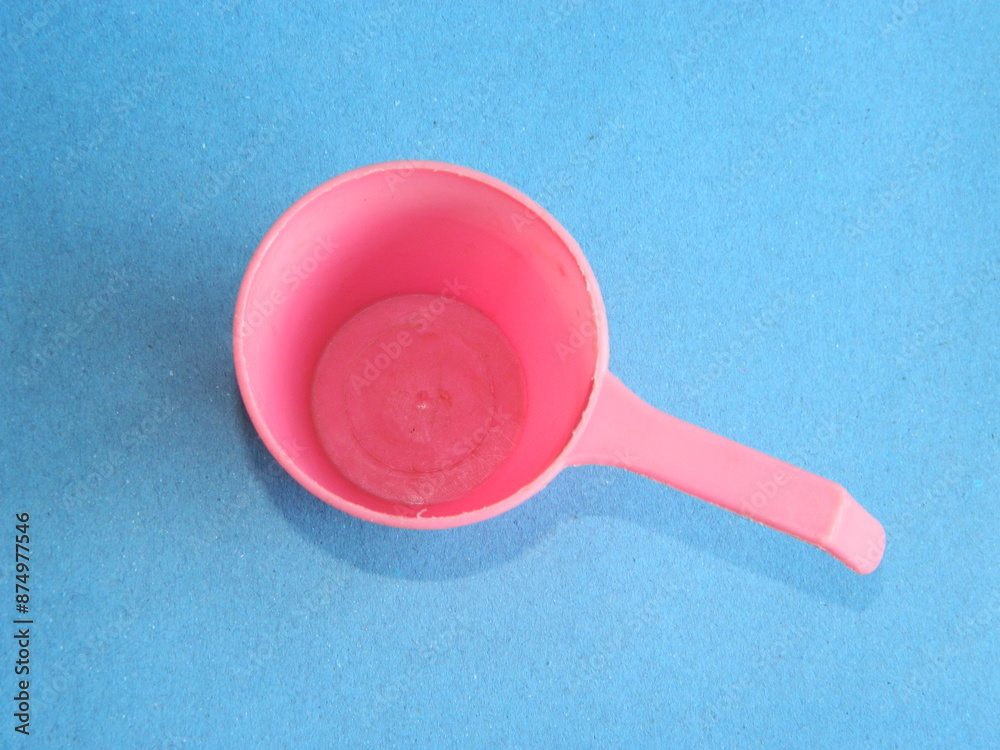 Macro photo of children's cooking toys with a blue background