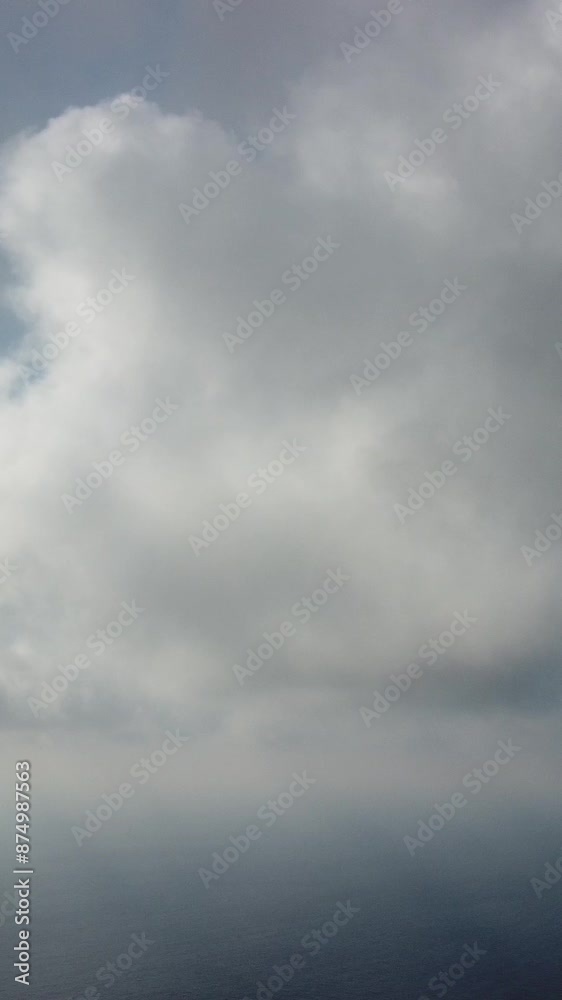 Drone flies over foggy and fluffy clouds. Aerial vertical view. Blue sky sun and sea fog. Abstract aerial nature summer ocean sunset sea and sky background. Vacation, vacation and holiday concept Drone flies over foggy and fluffy clouds. Aerial vertical view. Blue sky sun and sea fog. Abstract aerial nature summer ocean sunset sea and sky background. Vacation, vacation and holiday concept