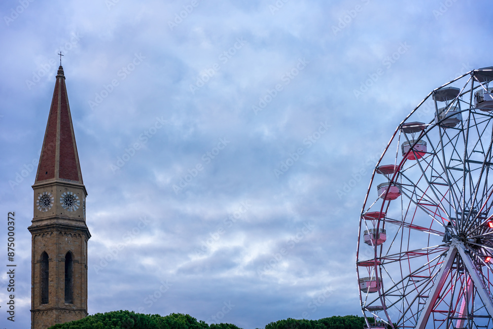 Arezzo Cathedral Tower and Ferris Wheel at Dusk in Tuscany Arezzo Cathedral Tower and Ferris Wheel at Dusk in Tuscany