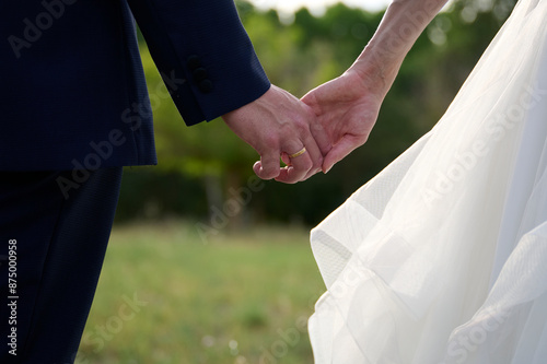 Holding hands at a wedding ceremony outdoors photo