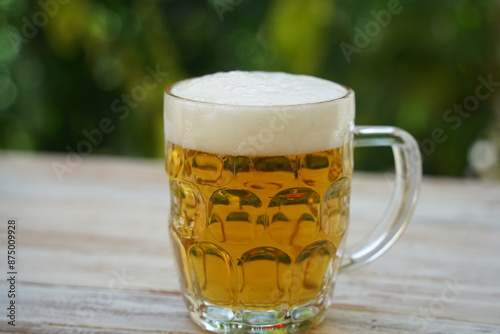 Photography Beer mug on the table with beer. Pilsner lager golden beer