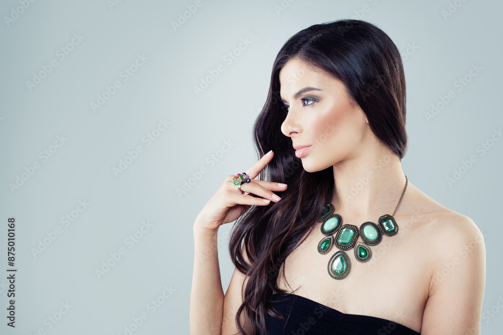 Obraz premium Nice woman with jewelry. Woman in a necklace and a ring with green stone. Beauty and accessories.