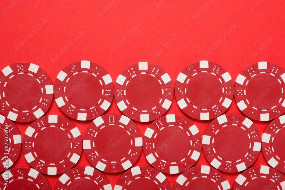 Casino chips on a red surface Casino chips on a red surface