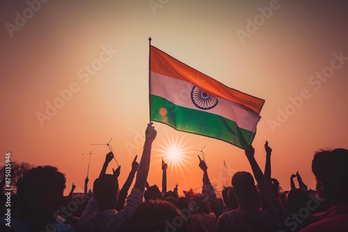 Silhouette of people celebrating with Indian flag at sunset, symbolizing unity, patriotism, and national pride for India's Independence Day
