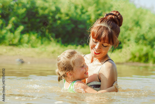 mom and child swim in the river