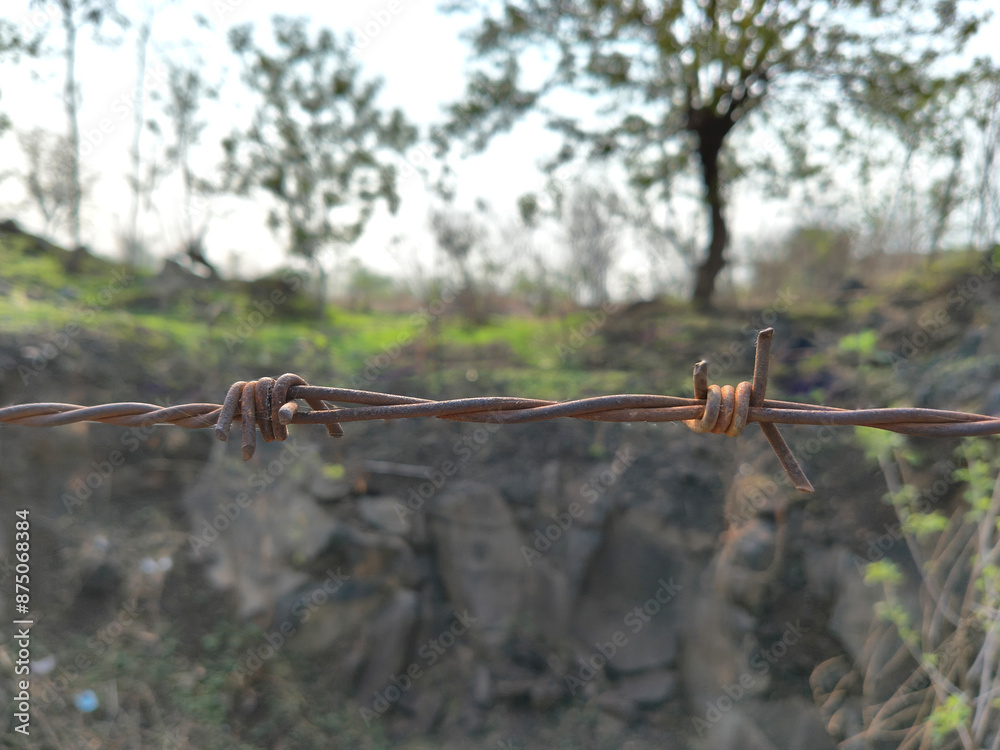 Barbed Wire for Fencing Kanta taar for Fence Poles Trees Antenna Wire with Hook close up metal thread with nails to protect property or land grung dark Barbed Wire for Fencing Kanta taar for Fence Poles Trees Antenna Wire with Hook close up metal thread with nails to protect property or land grung dark