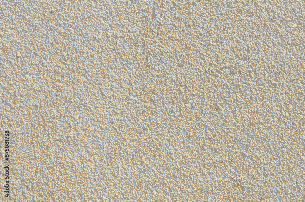 Fotografie Freestone wall covered with weathered and worn cement and sidewalk