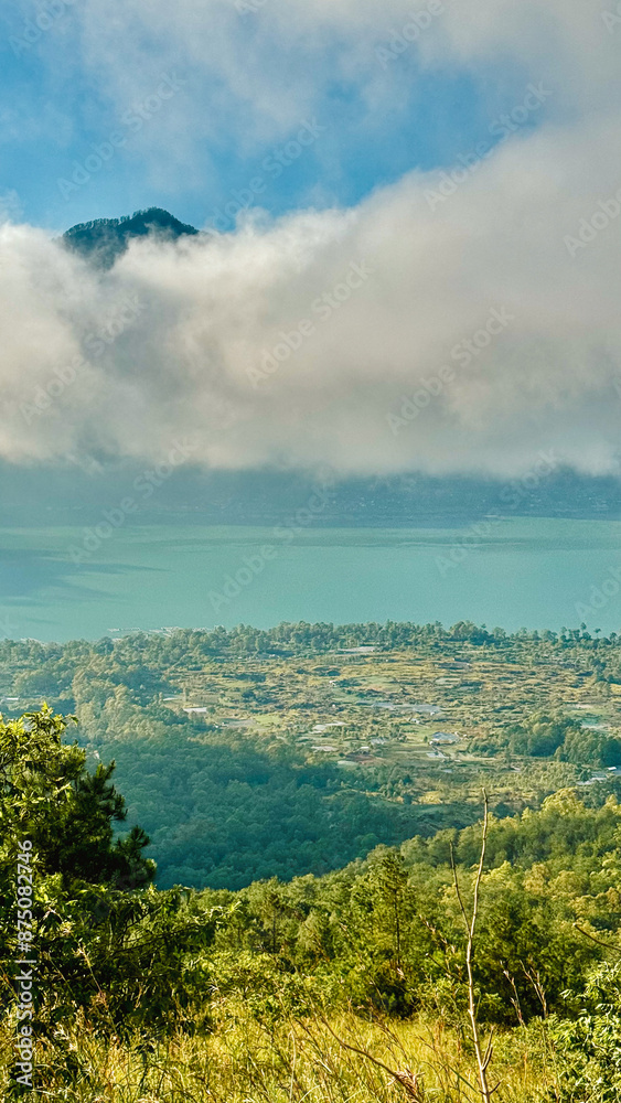 Fototapeta premium Scenic Overlook of Lake Batur with Cloud-Capped Peaks