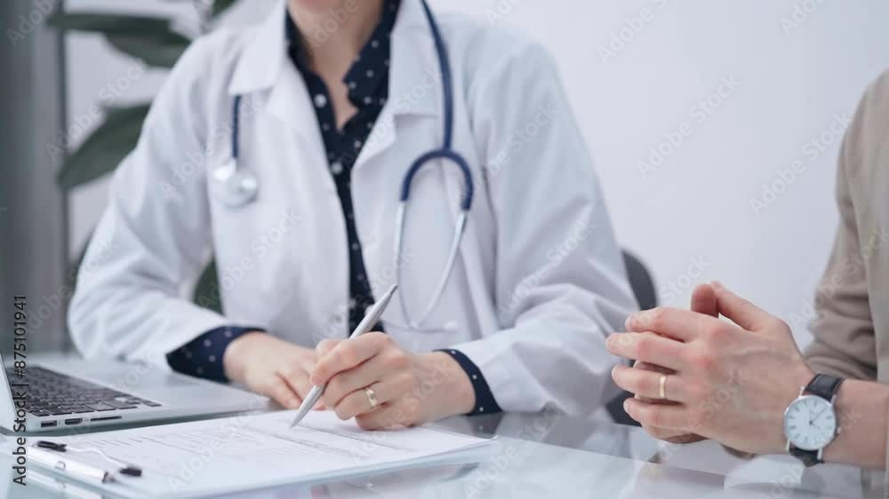 Doctor and patient are talking in clinic after health exam. Male physician is sitting and discussing test results with a senior woman. Medicine and pharmacy Doctor and patient are talking in clinic after health exam. Male physician is sitting and discussing test results with a senior woman. Medicine and pharmacy