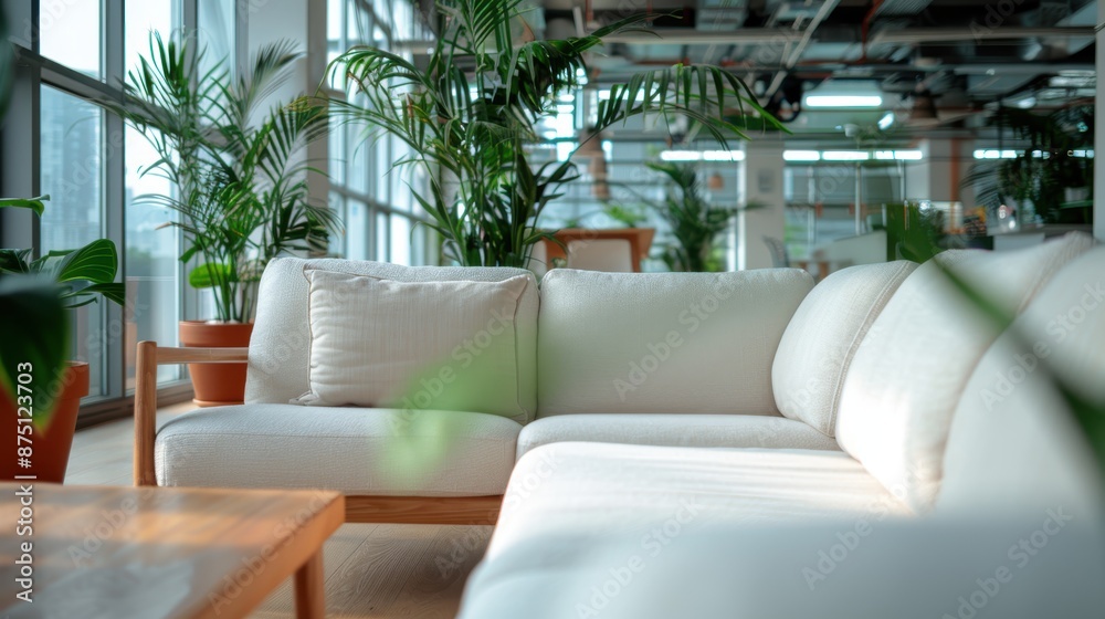 A bright and airy living space displaying a white sectional sofa complemented by various green plants, creating a fresh and inviting look with ample natural light. A bright and airy living space displaying a white sectional sofa complemented by various green plants, creating a fresh and inviting look with ample natural light.
