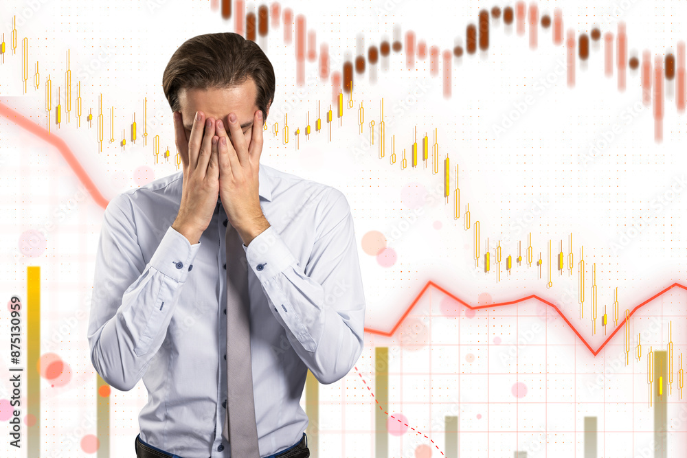 A stressed businessman with hands on his face against a financial chart background, depicting concept of market crash or loss A stressed businessman with hands on his face against a financial chart background, depicting concept of market crash or loss
