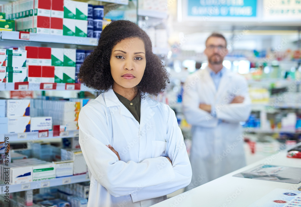 Healthcare, confidence and portrait of woman in pharmacy with teamwork, advice and serious in drug store. Pride, arms crossed and pharmacist with wellness, prescription medicine and health insurance Healthcare, confidence and portrait of woman in pharmacy with teamwork, advice and serious in drug store. Pride, arms crossed and pharmacist with wellness, prescription medicine and health insurance