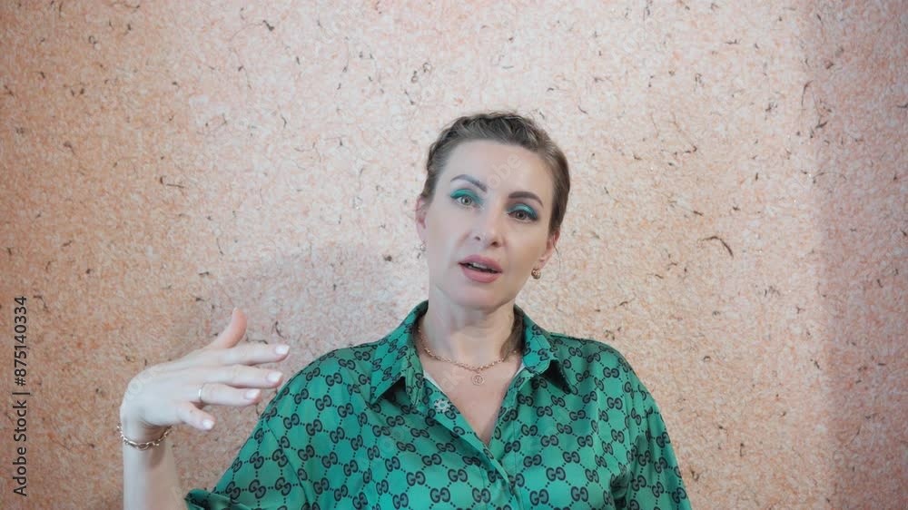 Attractive middle-aged woman with green eyes talks to camera. Attractive middle-aged woman with green eyes talks to camera.