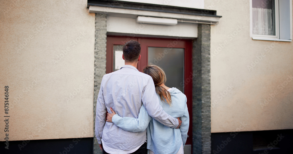 Newlyweds embracing outside their first home, planning a future together Newlyweds embracing outside their first home, planning a future together