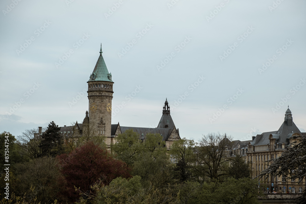 Obraz premium Luxembourg City, Luxembourg - April 25, 2024: Outdoor view of the Clock Tower of Spuerkees Bank during the sunset in the city center of Luxembourg the capital of Grand Duchy of Luxembourg