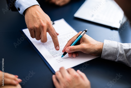 Quadro su tela Pointing The Finger In Front Of A Person Signing With Golden Pen On The Document