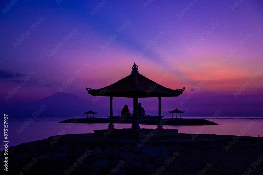 Golden hues embrace the dawn at Sanur, painting the sky with whispers of a new day. Golden hues embrace the dawn at Sanur, painting the sky with whispers of a new day.