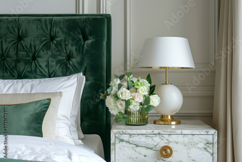 A modern minimalist green velvet bed with a night table on the side with a lamp photo