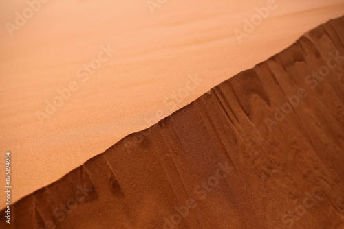 Sandy background: the top of a sand dune in the Namibian desert. Selective focus