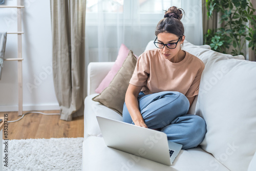 Young unemployed jobless woman sitting at home hoping for easy money and quick cash earnings from internet, work online for passive income paid surveys website surfing click for cash affiliate program