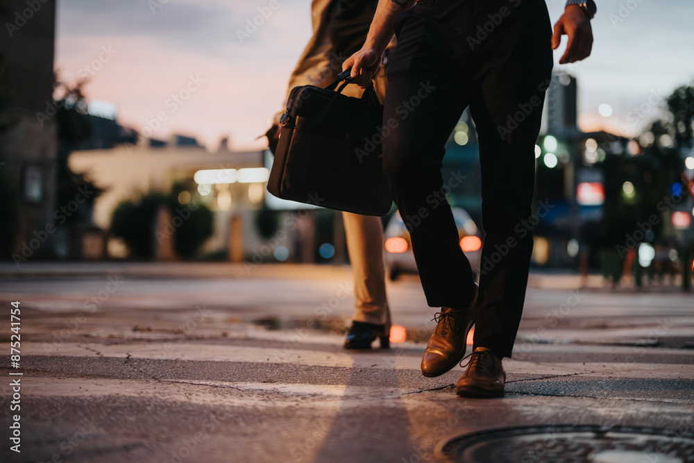 Two business professionals walking on a city street at night, one carrying a briefcase. The scene highlights night business, professionalism, and urban lifestyle. Two business professionals walking on a city street at night, one carrying a briefcase. The scene highlights night business, professionalism, and urban lifestyle.
