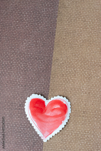 paper heart on brown paper with weave pattern