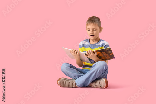 Shocked little boy reading ...