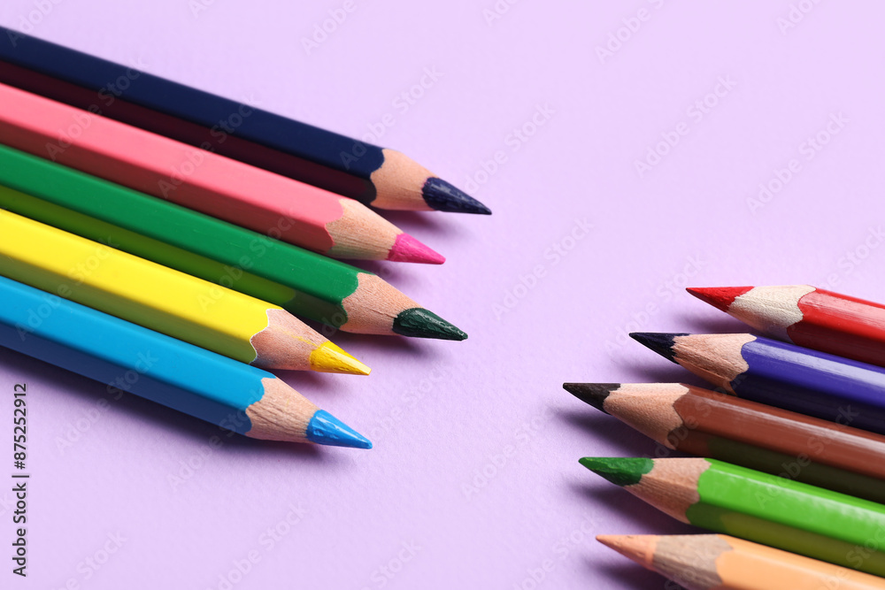 Colorful pencils on purple background, closeup Colorful pencils on purple background, closeup