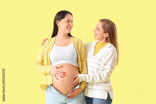 Mature doula hugging pregna...