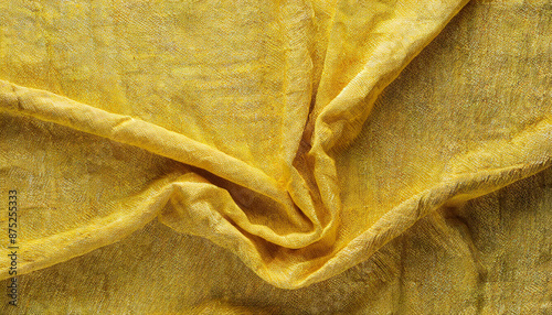 Close-Up of Wrinkled Yellow Linen Fabric with Natural Texture and Soft Folds, Creating an Abstract Background in a Warm, Vibrant Shade photo