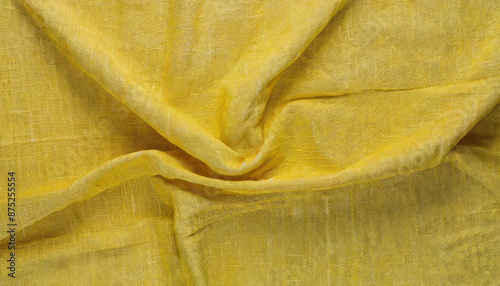 Close-Up of Wrinkled Yellow Linen Fabric with Natural Texture and Soft Folds, Creating an Abstract Background in a Warm, Vibrant Shade photo