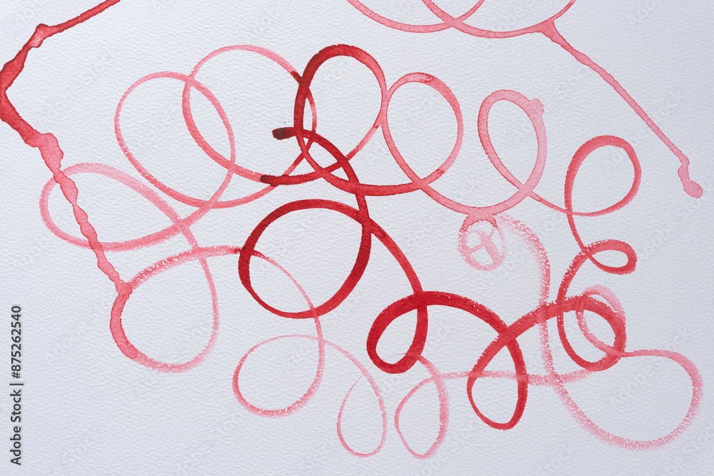 curly cursive script line in red on paper curly cursive script line in red on paper
