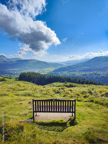 A bench overlooking a beautiful mountain landscape of the Mawddach river valley and estuary. View from the scenic Precipice Walk hike. Dolgellau, Barmouth, Gwynedd, Snowdonia National Park, Wales photo