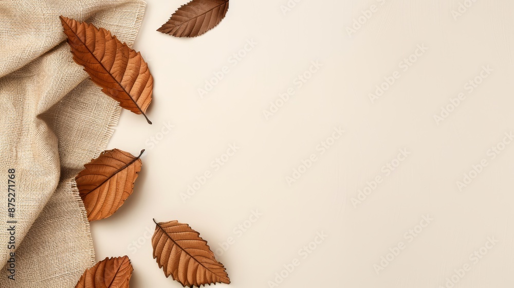 Autumn background with brown leaves and burlap fabric on the left side of the image Autumn background with brown leaves and burlap fabric on the left side of the image