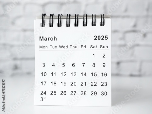 March 2025 white monthly desk calendar on a table