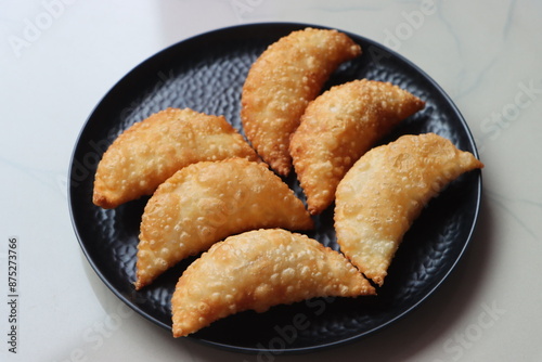 Karanji or gujia, Kajjikayalu, Indian festival food, stuffed with coconut stuffing