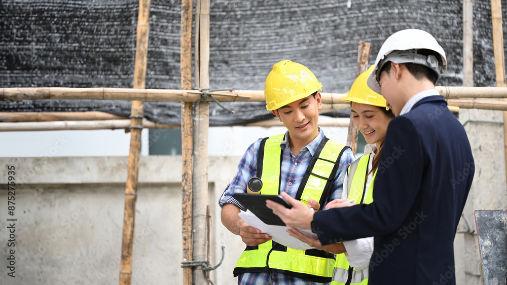 A businessman in a suit and workers review project details on a construction site and copy space for text, Bridging business acumen and hands-on expertise in construction projects A businessman in a suit and workers review project details on a construction site and copy space for text, Bridging business acumen and hands-on expertise in construction projects