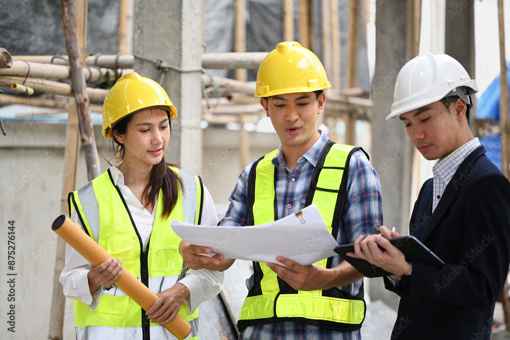 A manager in a suit and construction team reviews blueprints, discusses details passionately, Teamwork and precision in planning at an active construction site A manager in a suit and construction team reviews blueprints, discusses details passionately, Teamwork and precision in planning at an active construction site