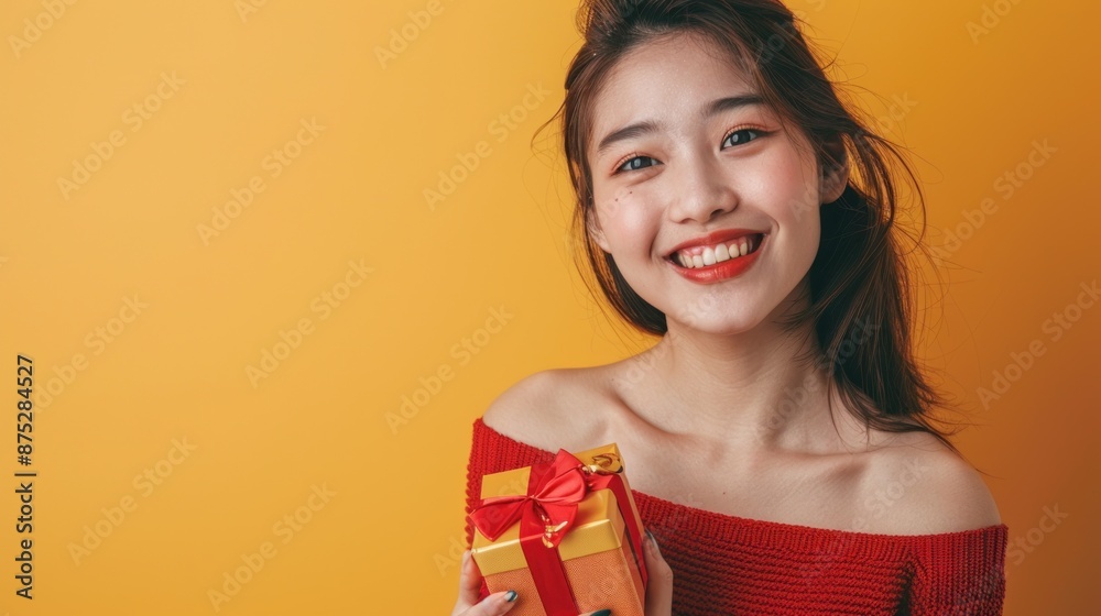 Close-up of a Japanese teenage girl smiling and holding a gift box, wearing a cute red top, standing in front of a yellow background, Portrait close-up, hyper-realistic, high detail, photorealistic, Close-up of a Japanese teenage girl smiling and holding a gift box, wearing a cute red top, standing in front of a yellow background, Portrait close-up, hyper-realistic, high detail, photorealistic,