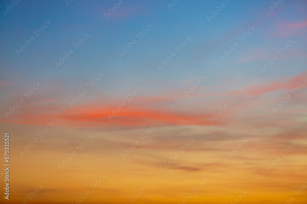 Fototapeta premium Clouds and orange sky,Real majestic sunrise sunset sky background with gentle colorful clouds without birds.Panorama, large 