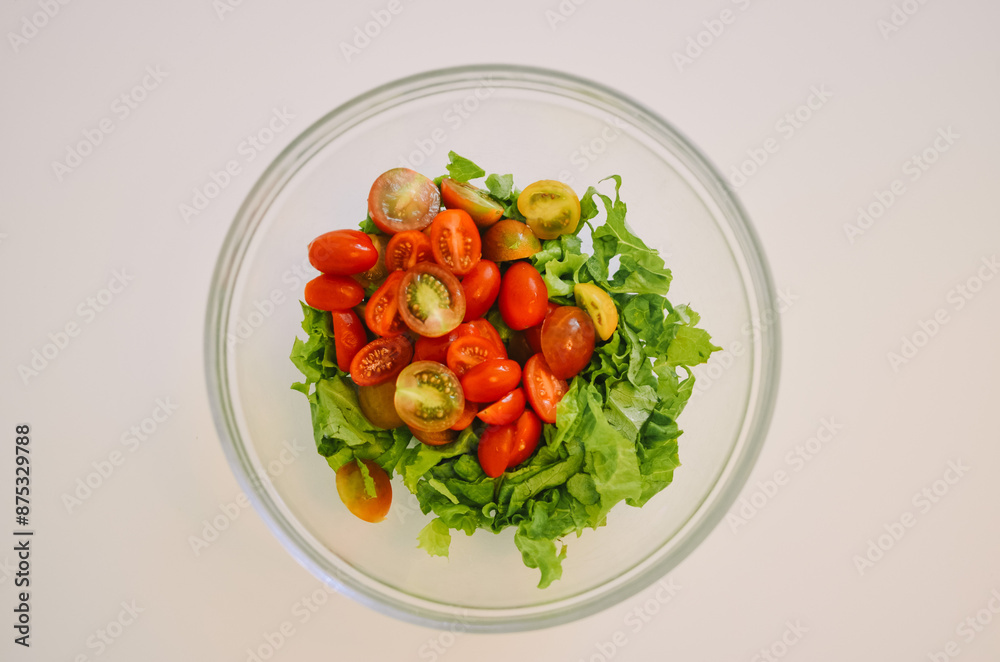salad bowl with cherry tomatoes and lettuce on a white background salad bowl with cherry tomatoes and lettuce on a white background