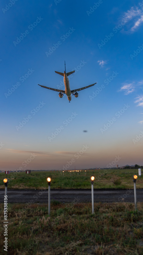 Fototapeta premium An airplane in the sky coming in for a landing. 