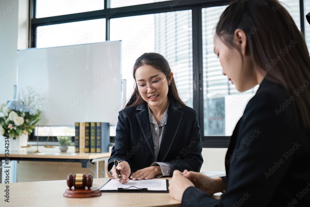 Female Lawyer Providing Legal Advice to Client in Modern Office Setting with Documents and Gavel on Desk Female Lawyer Providing Legal Advice to Client in Modern Office Setting with Documents and Gavel on Desk
