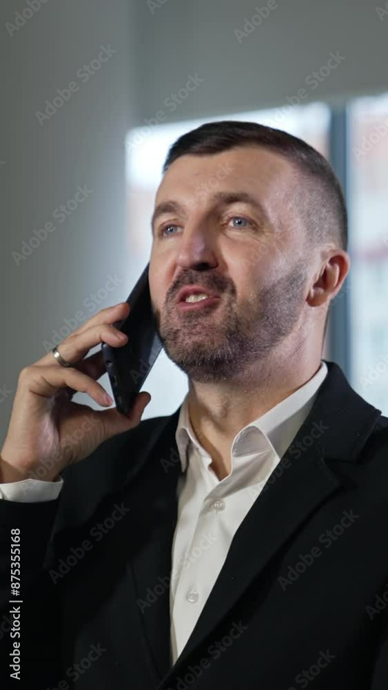 Business talk on the mobile phone. Business call to the partners or clients. Businessman having a conversation on his smartphone. Vertical video Business talk on the mobile phone. Business call to the partners or clients. Businessman having a conversation on his smartphone. Vertical video
