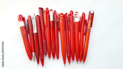  Red fountain pens on a light background. Stationery office supplies. Red pens.