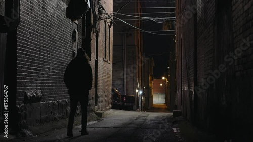 Mysterious person walking down dark alley in city 4k
